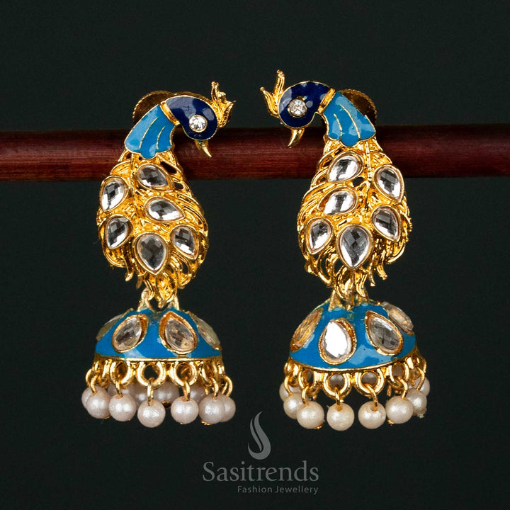 Gold-plated peacock jhumka earrings with kundan stones and pearl drops