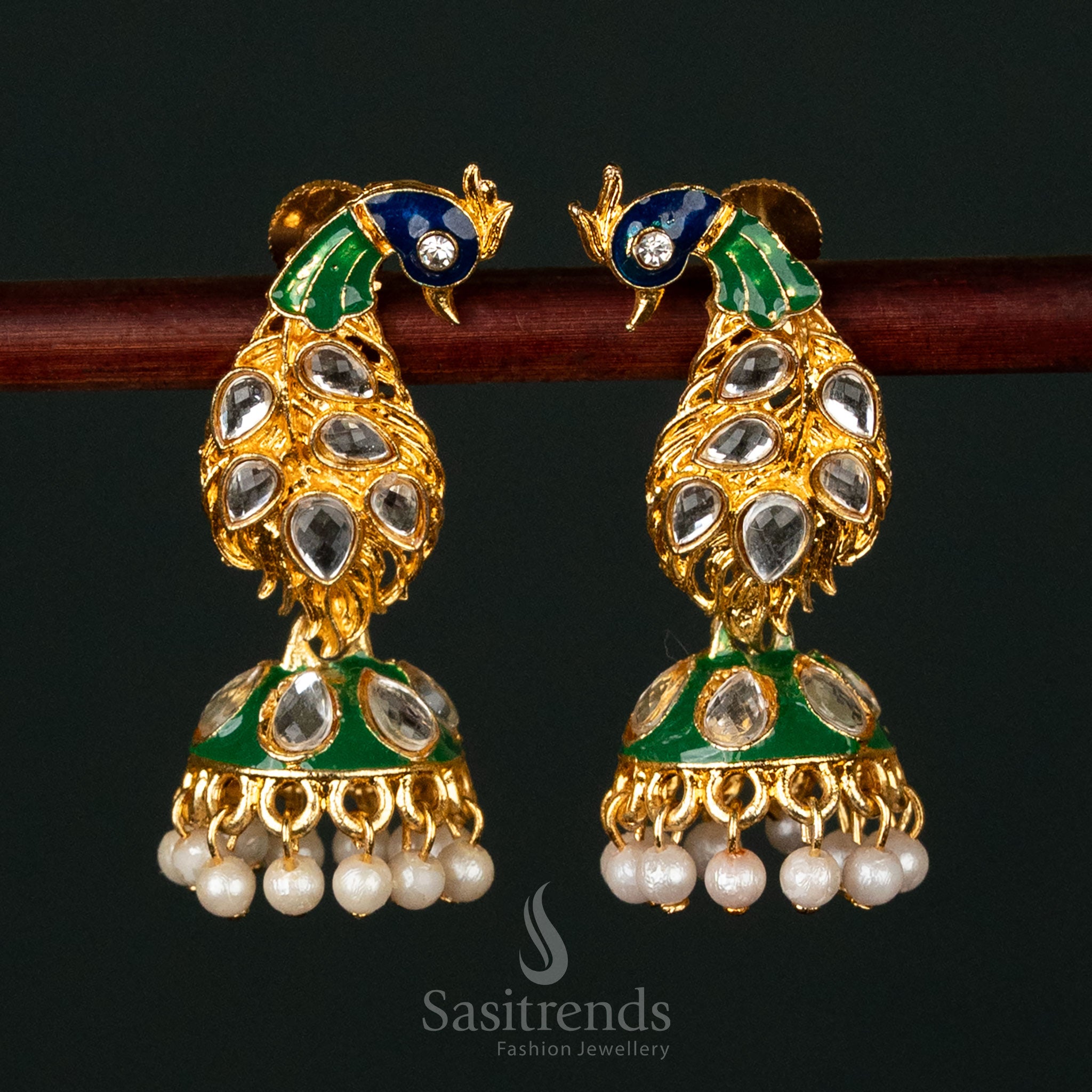 Elegant gold-plated earrings featuring a peacock design with kundan stones and pearls