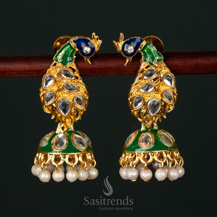 Elegant gold-plated earrings featuring a peacock design with kundan stones and pearls