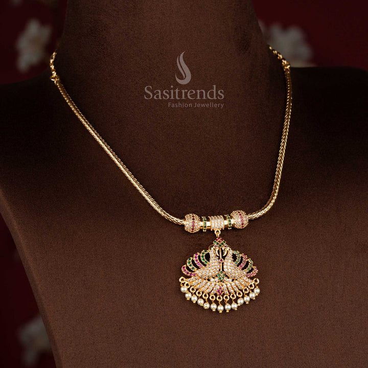 Sasitrends micro gold plated pendant chain necklace showcasing a temple-style dual peacock pendant structure with multi colour AD stone detailing and pearl fringe finish, best worn for poojas, special occasions, and classic silk sarees.