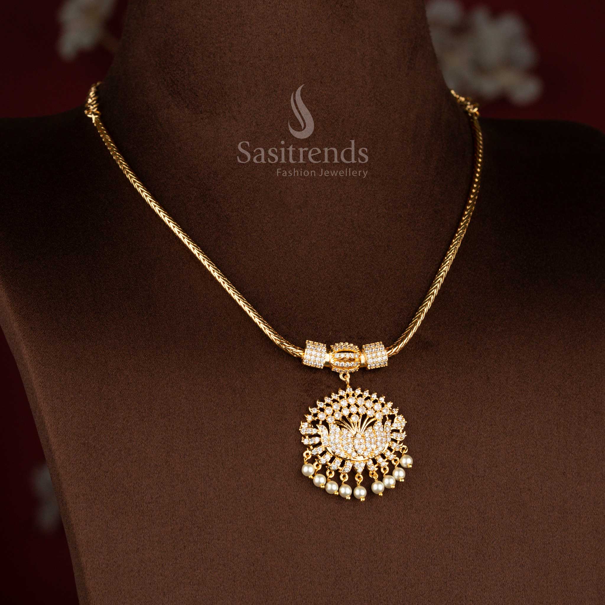 Sasitrends micro gold plated one gram pendant chain necklace featuring a layered lotus motif pendant structure fully set with white AD stones and finished with pearl drop detailing, paired with a textured chain for a rich 24K real gold look and traditional elegance.