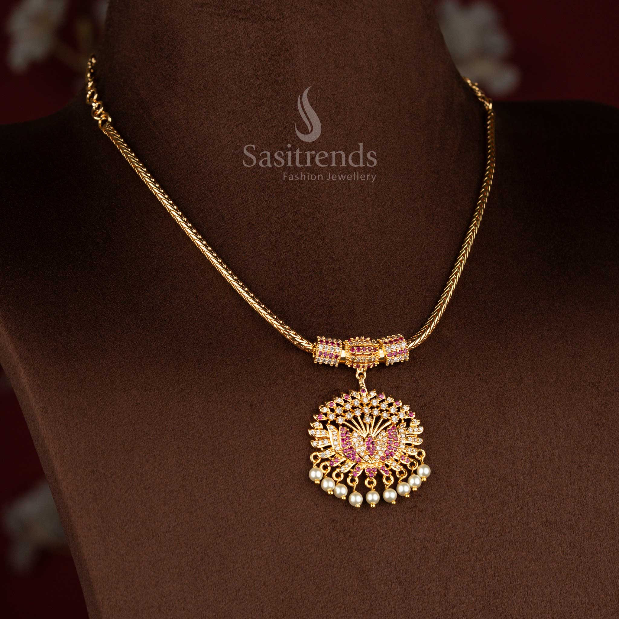 Sasitrends traditional pendant chain necklace featuring a sculpted lotus design pendant structure adorned with white AD stones and white ruby accents, paired with pearl hangings and a smooth chain for a gold-like traditional finish.
