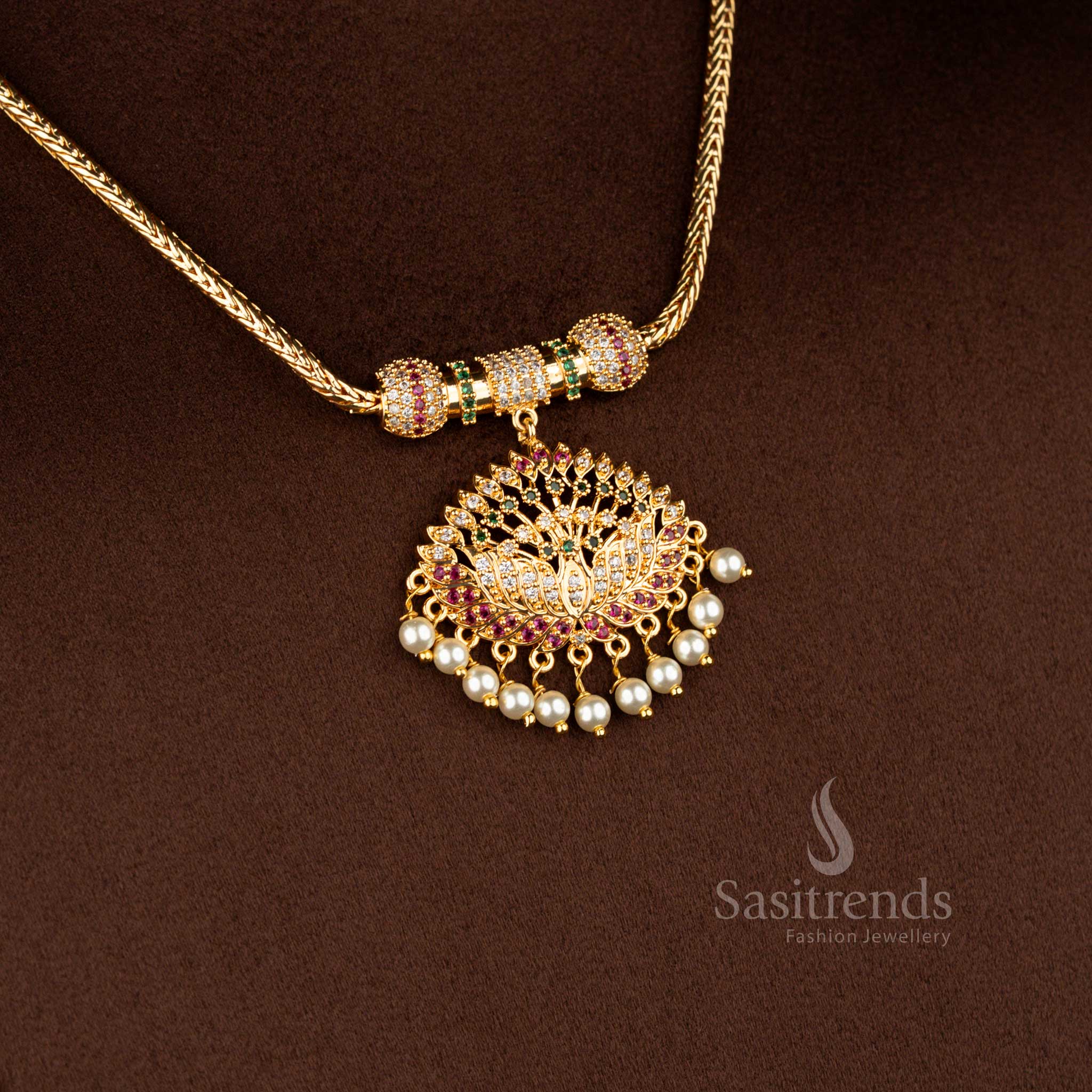 Sasitrends micro gold plated one gram pendant chain necklace featuring a grand lotus motif pendant structure embellished with multi colour AD stones and pearl drop accents, paired with a gold-tone chain for a festive 24K real gold look.