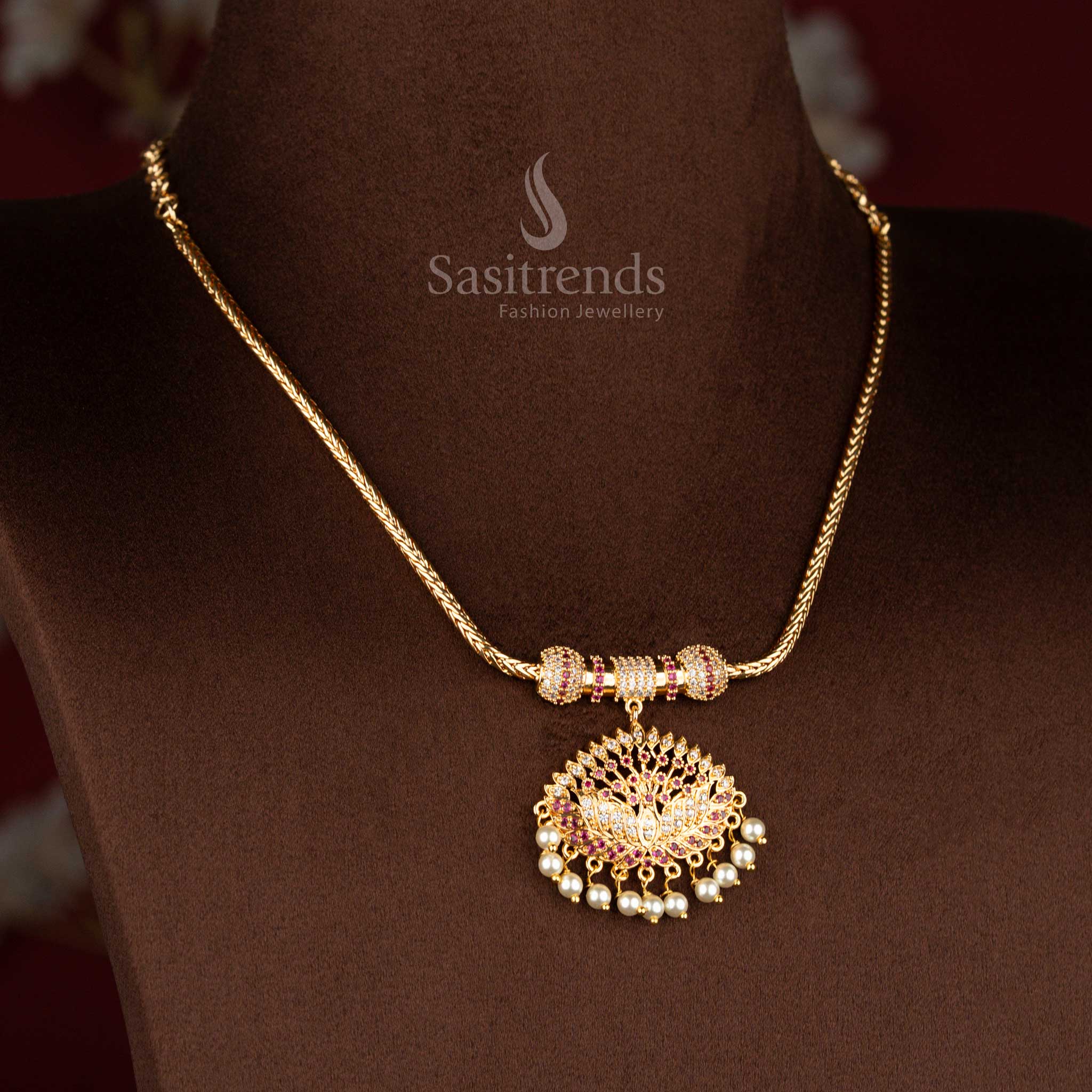 Sasitrends micro gold plated one gram pendant chain necklace crafted with a lotus motif pendant structure accented by white AD stones and white ruby highlights, finished with pearl drop detailing for a refined 24K gold-like look.