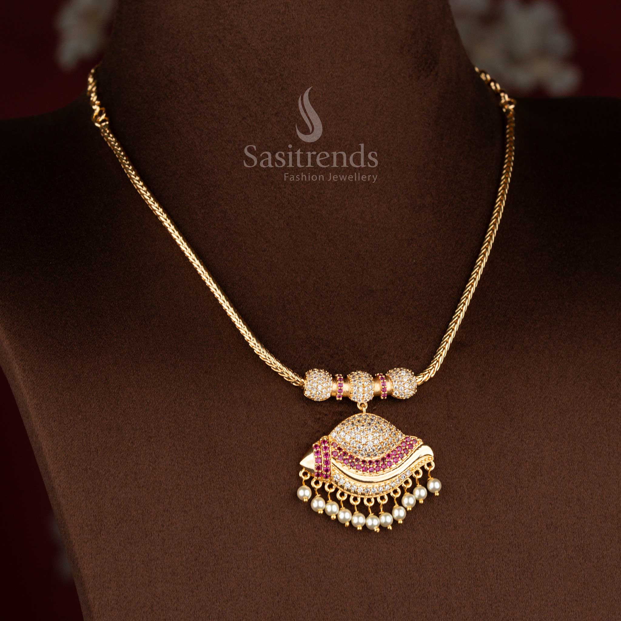 Sasitrends micro gold plated pendant chain necklace designed with a paisley crescent-inspired pendant structure detailed using white AD stones and white ruby elements, completed with pearl fringe for a refined heritage look.
