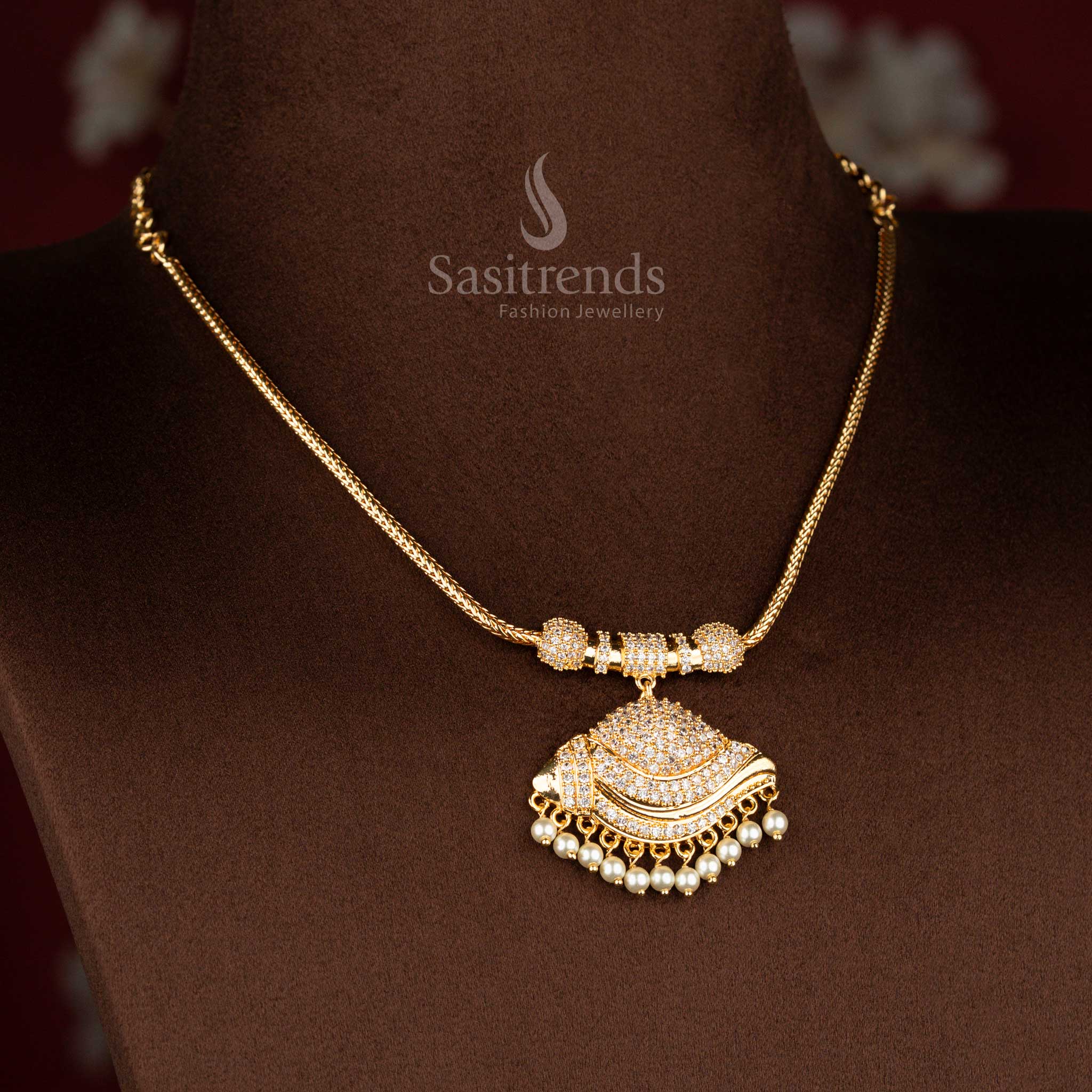 Sasitrends micro gold plated pendant chain necklace showcasing a paisley-inspired crescent pendant structure with dense white AD stone setting and pearl fringe detailing, completed with a smooth gold-tone chain for a heritage look.