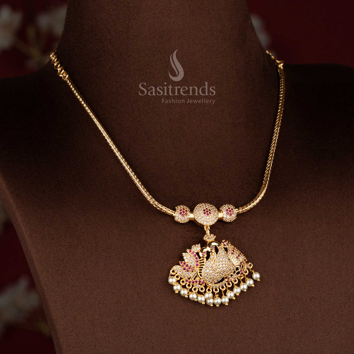 Sasitrends micro gold plated one gram pendant chain necklace crafted with a single peacock pendant structure accented by white AD stones and white ruby highlights, finished with pearl drops for a rich traditional appearance.