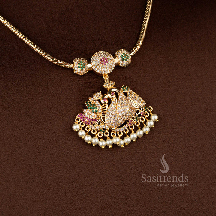 Sasitrends traditional pendant chain necklace crafted with a peacock motif highlighted by multi colour AD stones and layered pearl hangings, making it a perfect choice for weddings and grand traditional occasions.