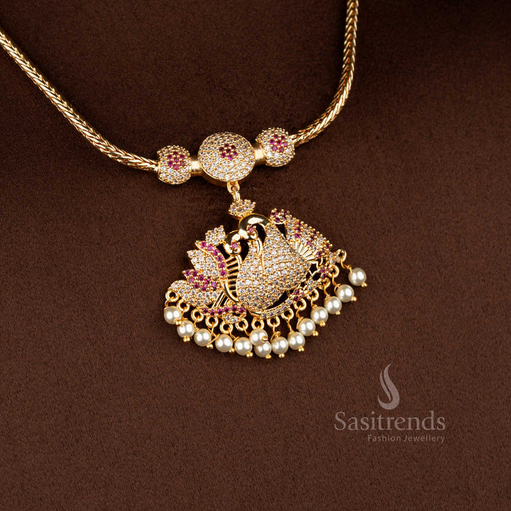 Sasitrends traditional pendant chain necklace featuring a peacock-inspired design adorned with white AD stones and white ruby accents, paired with pearl fringe detailing for festive occasions and silk saree wear.