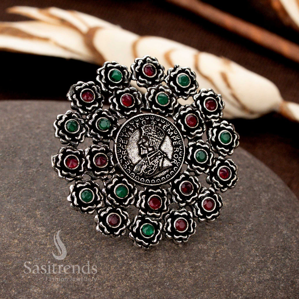A luxe oxidised silver floral coin ring with meticulously hand-designed patterns and captivating ruby-green stone highlights, making it an artistic statement piece - Sasitrends