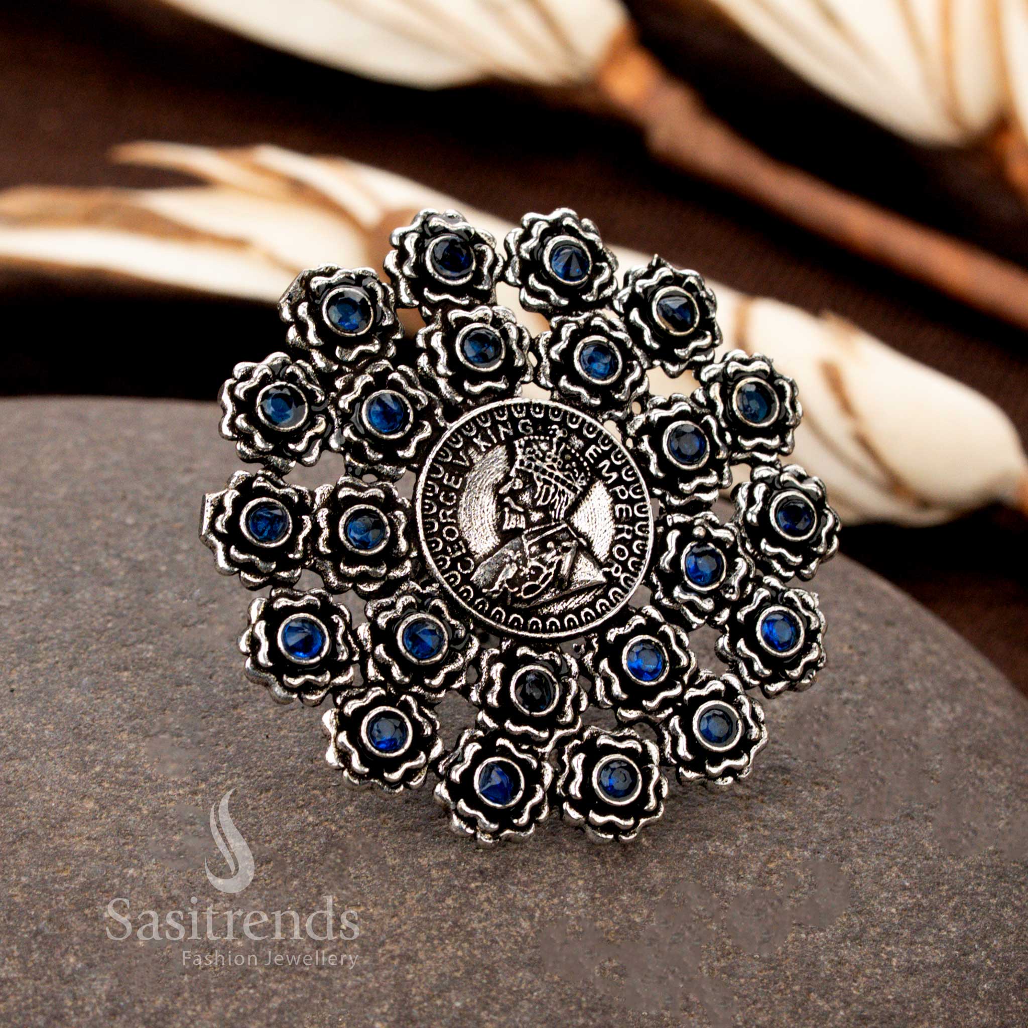 A vintage handcrafted oxidised floral coin ring with detailed etchings and a royal blue gemstone, blending antiquity with modern allure - Sasitrends