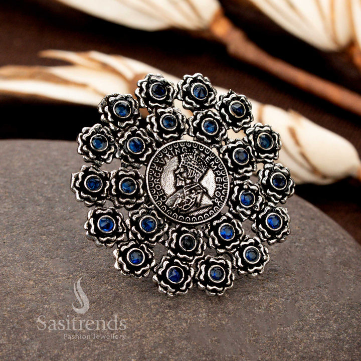 A vintage handcrafted oxidised floral coin ring with detailed etchings and a royal blue gemstone, blending antiquity with modern allure - Sasitrends