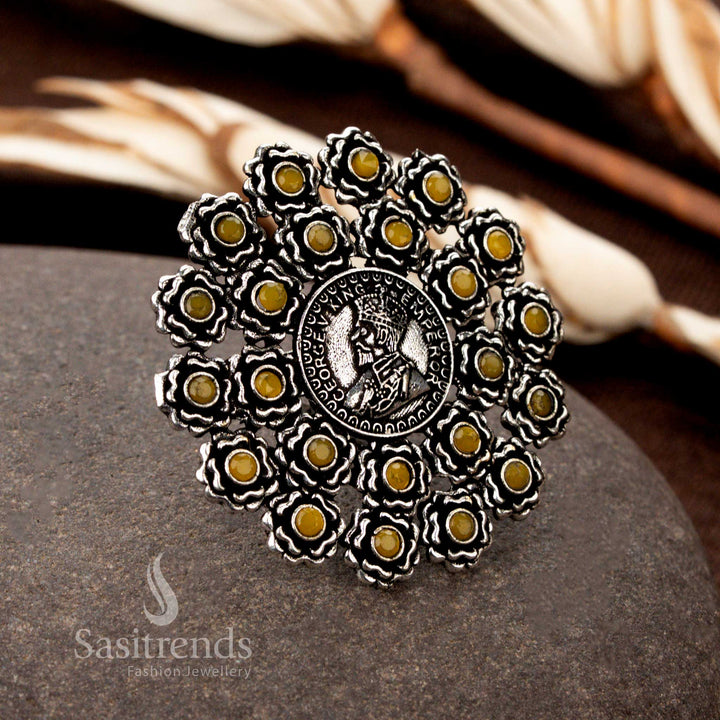 A unique handmade oxidised silver ring boasting floral coin motifs and a vibrant yellow gemstone, making it a stunning addition to traditional jewellery collections - Sasitrends