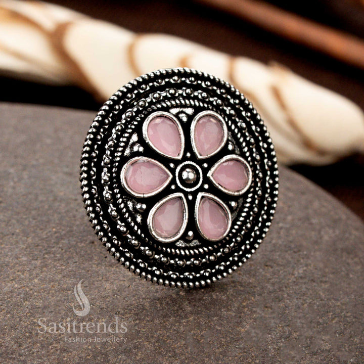A chic handmade oxidised floral ring featuring intricate petal motifs and a radiant rose pink gemstone, perfect for adding a feminine touch to ethnic jewellery - Sasitrends