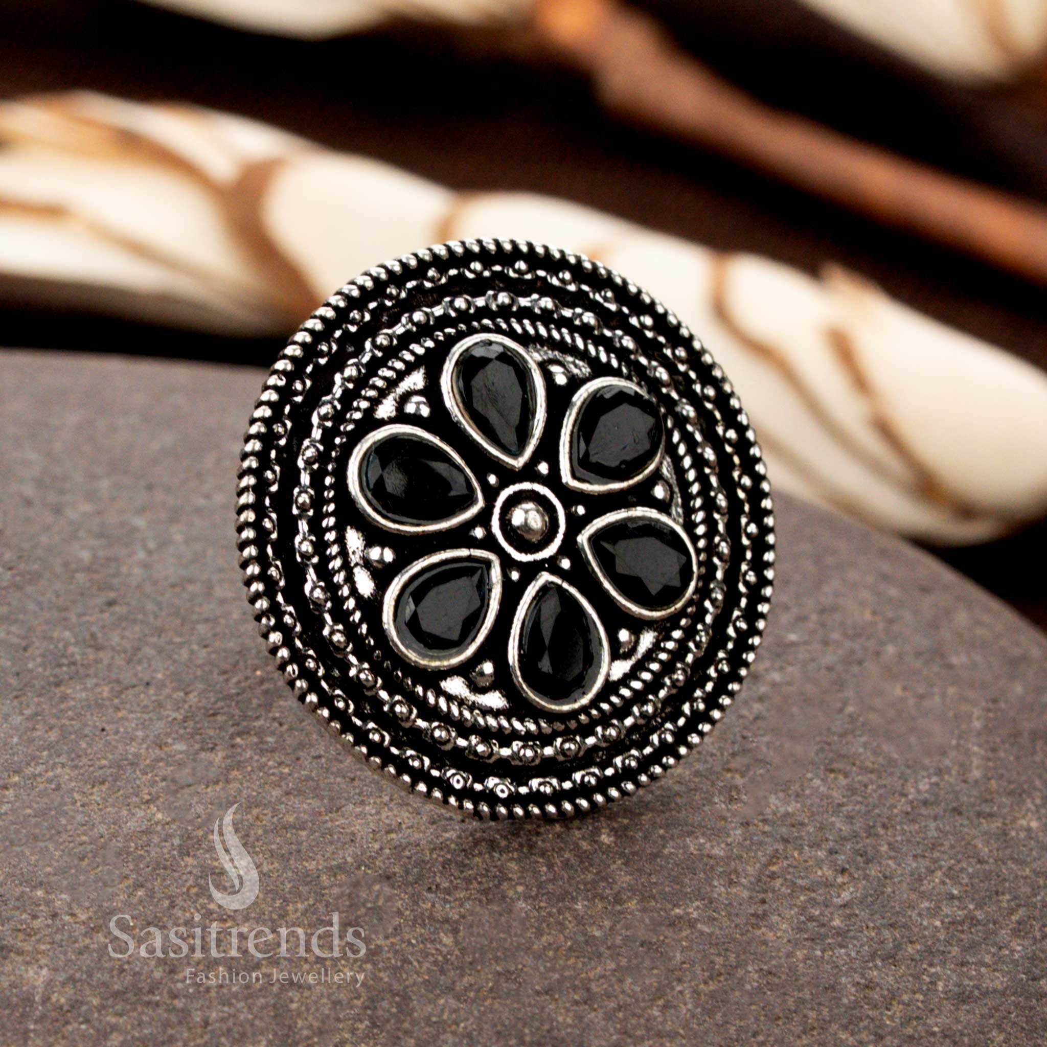 A bold oxidised floral adjustable ring with exquisite handcrafted petal motifs and a deep black stone centerpiece, perfect for a striking and elegant look - Sasitrends