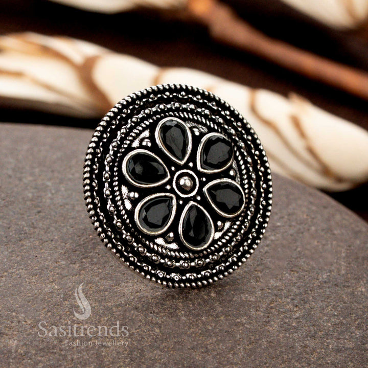 A bold oxidised floral adjustable ring with exquisite handcrafted petal motifs and a deep black stone centerpiece, perfect for a striking and elegant look - Sasitrends