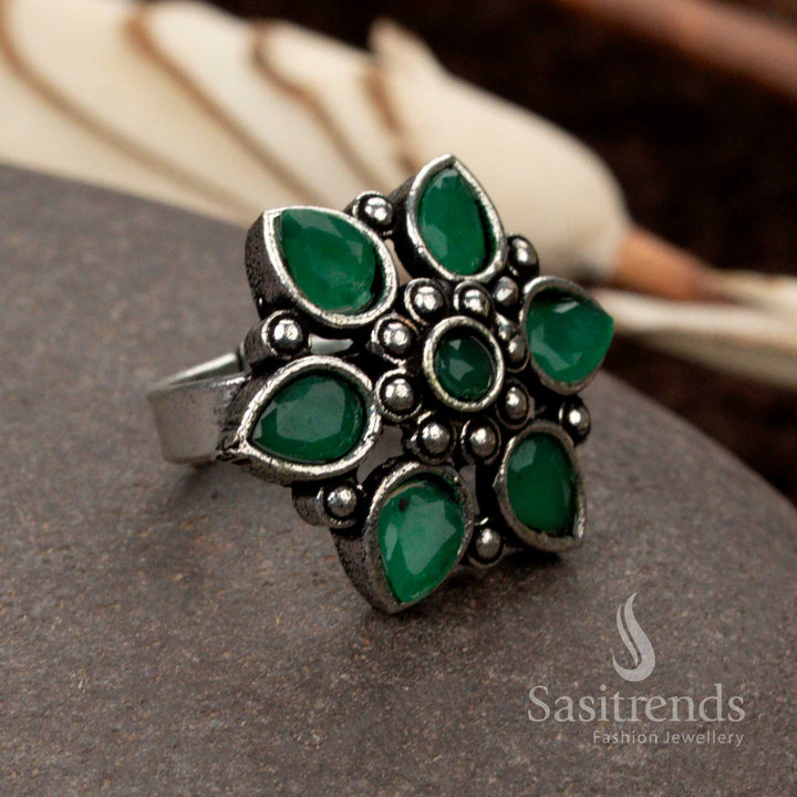 Beautiful oxidised floral ring with a rich green stone, representing prosperity and nature-inspired elegance - Sasitrends