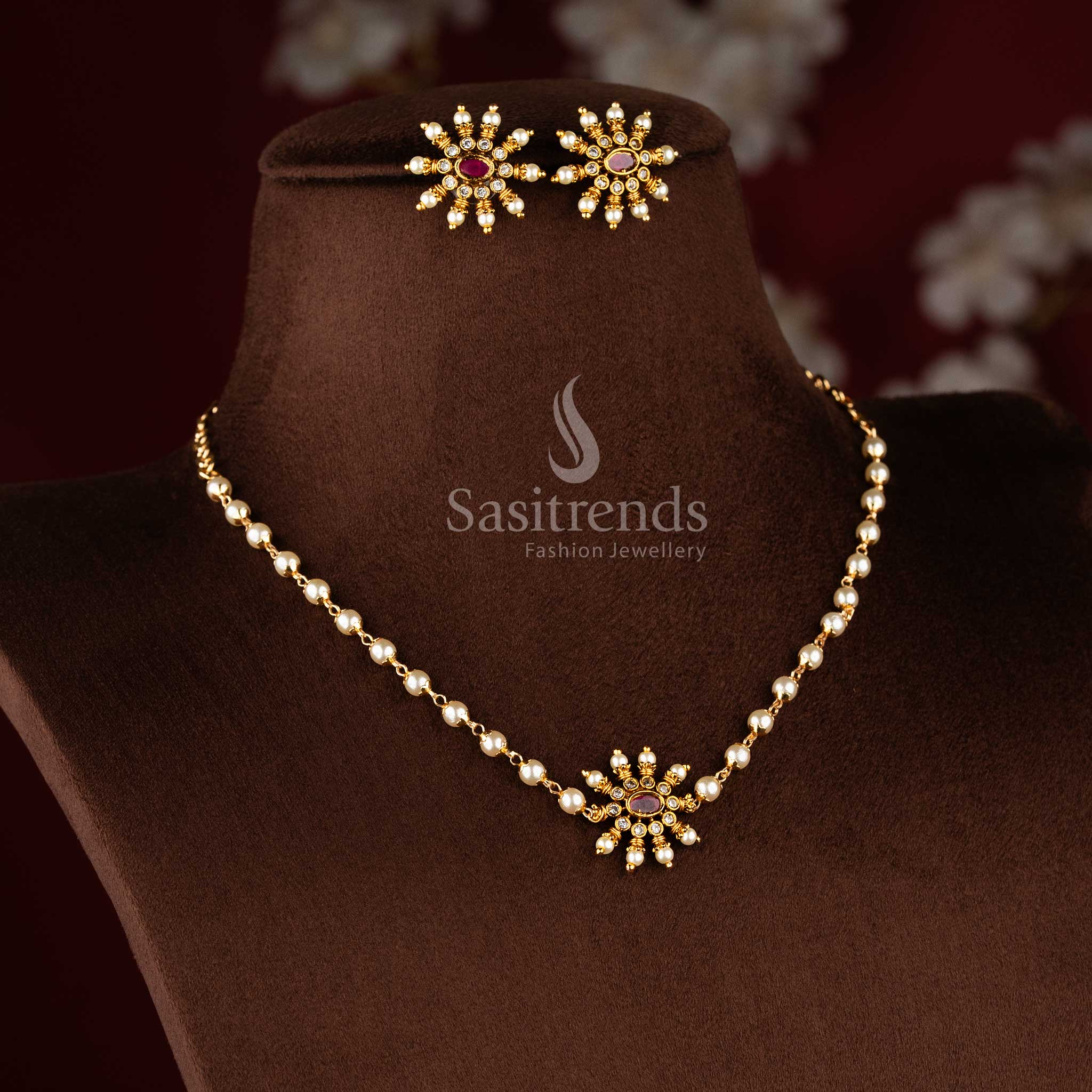 Traditional matte gold necklace featuring a central sunburst floral pendant and elegant pearl string 1949 - Sasitrends