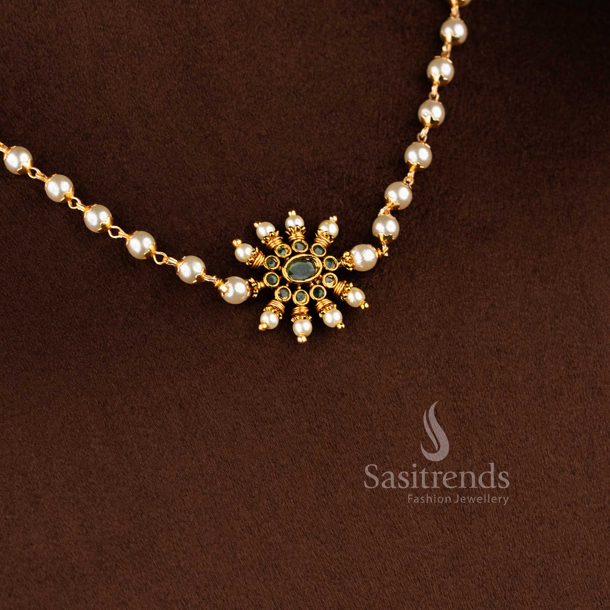 Traditional matte gold necklace featuring a central sunburst floral pendant and elegant pearl string 1949 - Sasitrends