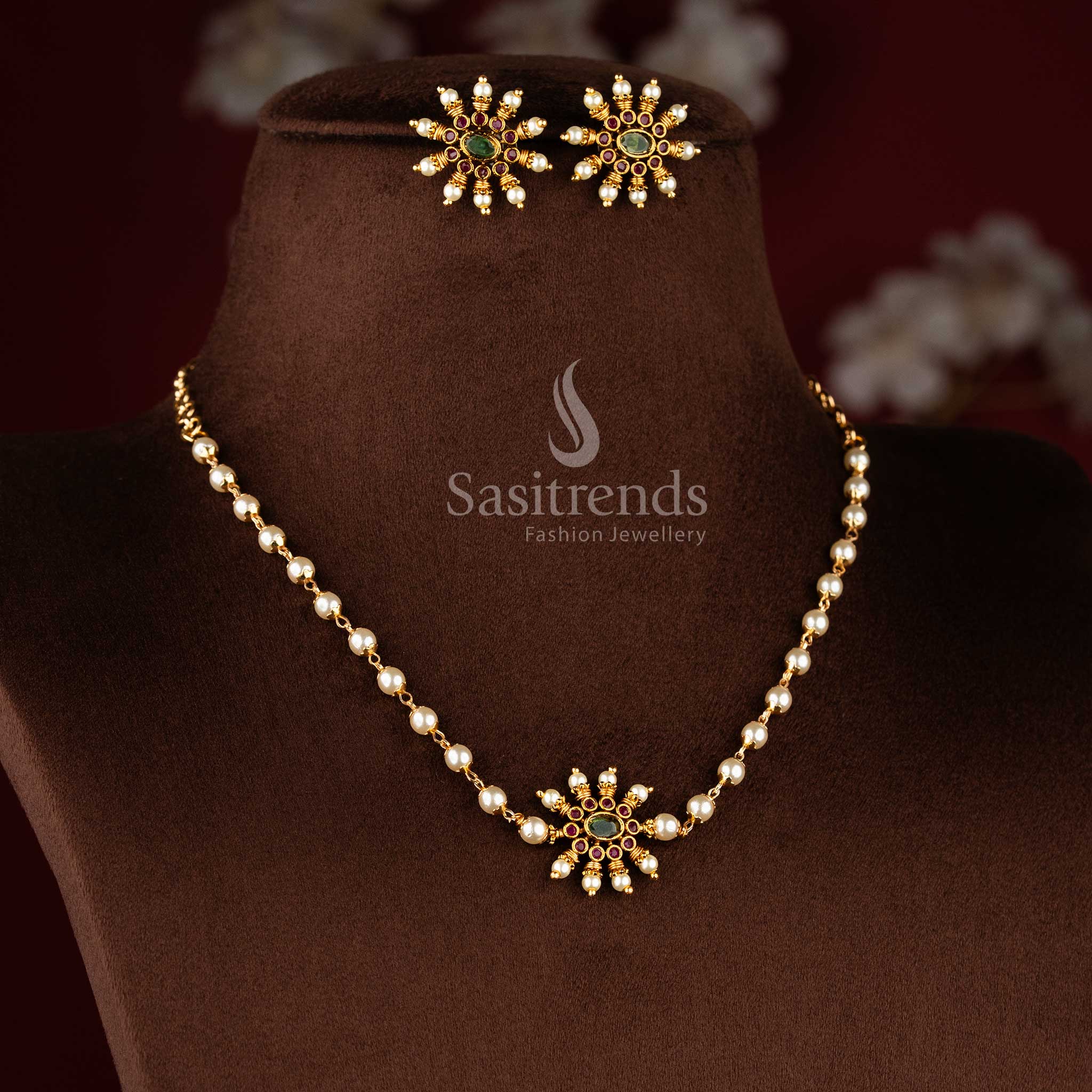 Traditional matte gold necklace featuring a central sunburst floral pendant and elegant pearl string 1949 - Sasitrends