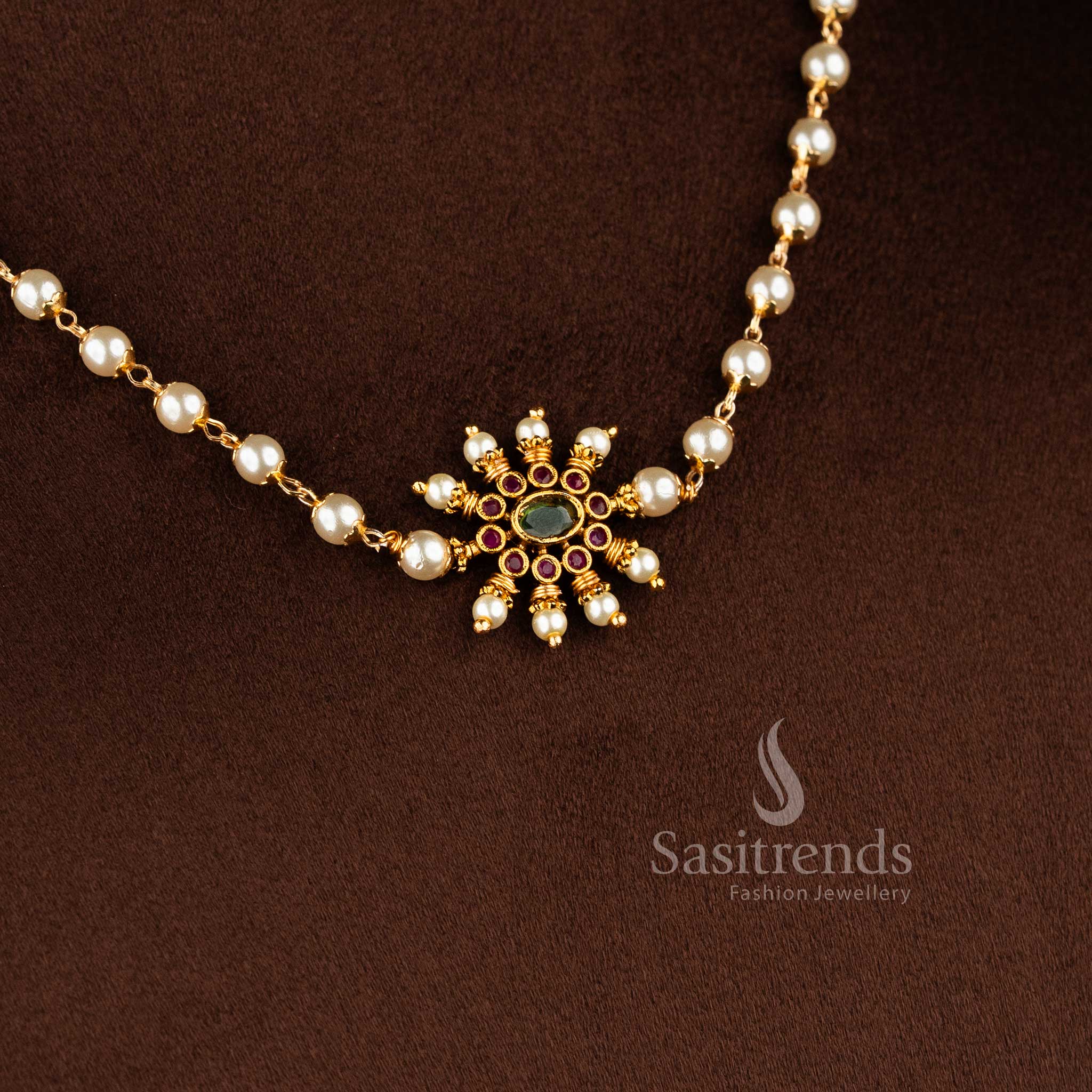 Matte gold necklace featuring a central sunburst floral pendant and elegant pearl string 1949 - Sasitrends