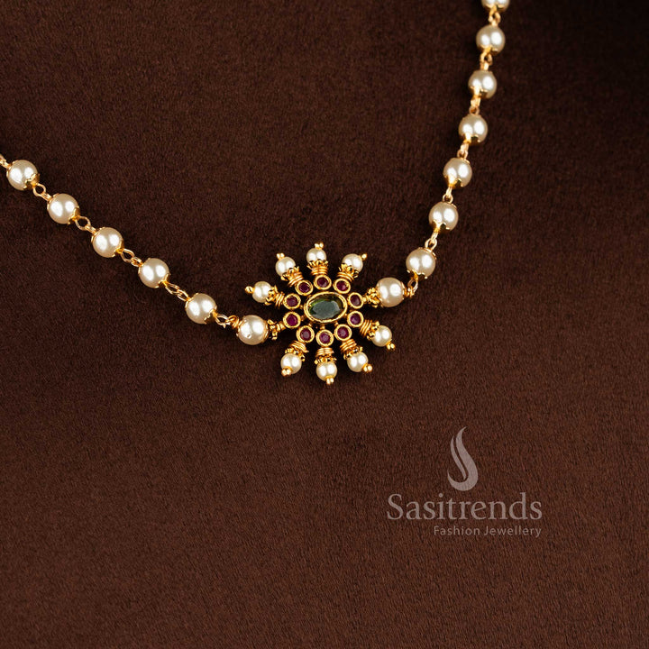 Matte gold necklace featuring a central sunburst floral pendant and elegant pearl string 1949 - Sasitrends
