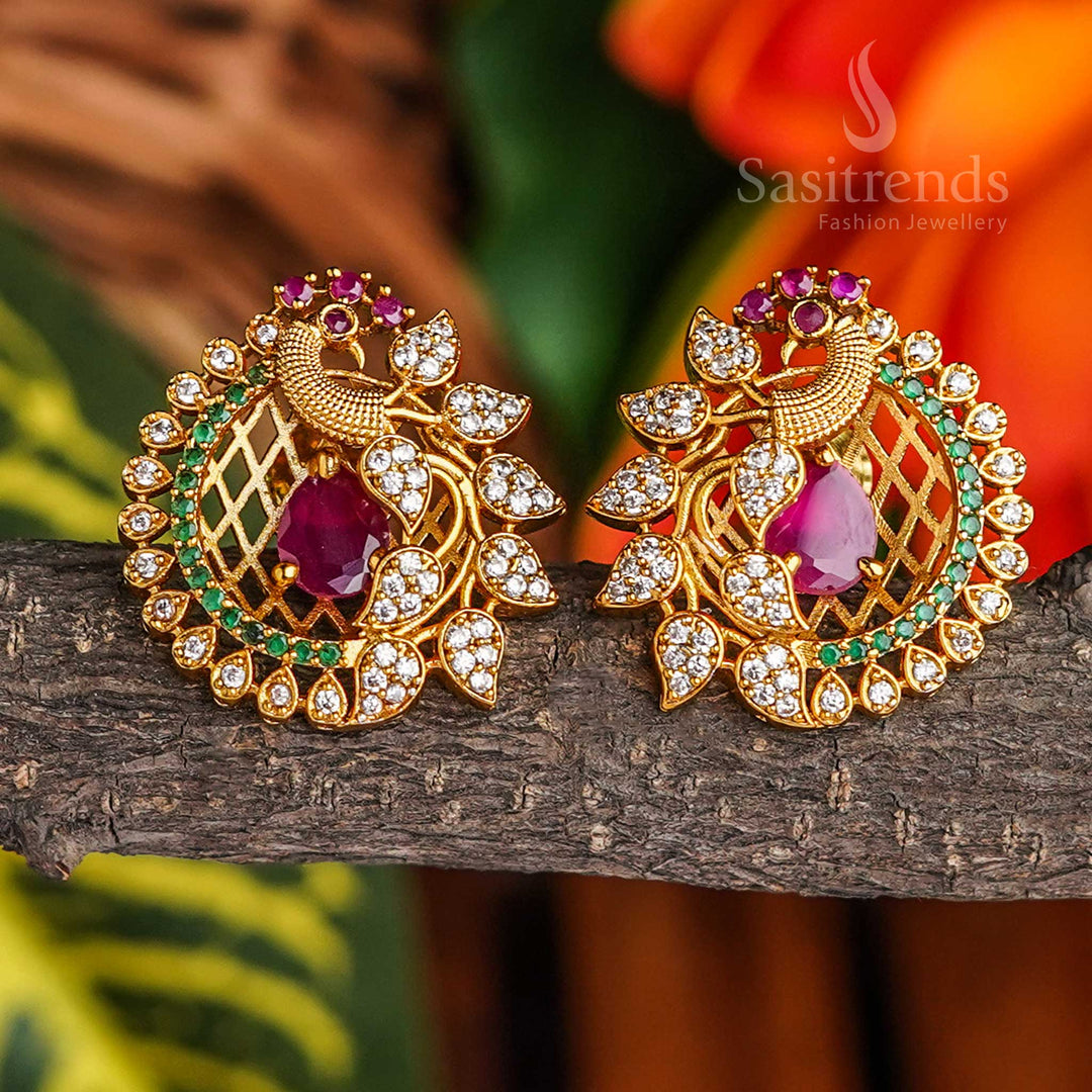 Feathered elegance temple-style peacock stud earrings in matte gold plating with AD stones, radiating heritage grace and ethnic glamour as a refined ear embellishment by Sasitrends