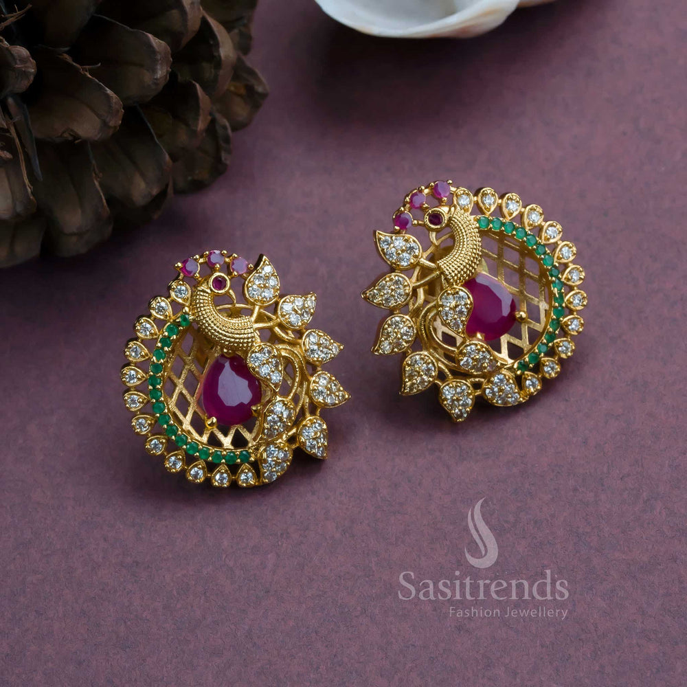 Temple jewellery-style peacock earrings with matte gold plating and AD studs, crafted with feathered flair, elegant drape, and royal grandeur for festive occasions by Sasitrends