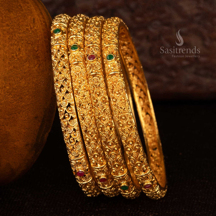 Floral pattern gold bangles with ruby accents in matte gold finish - Sasitrends