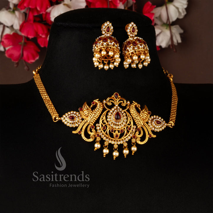 Opulent temple-style matte gold choker necklace set with stunning ruby-white American diamonds, adorned with a majestic peacock and floral pattern - Sasitrends