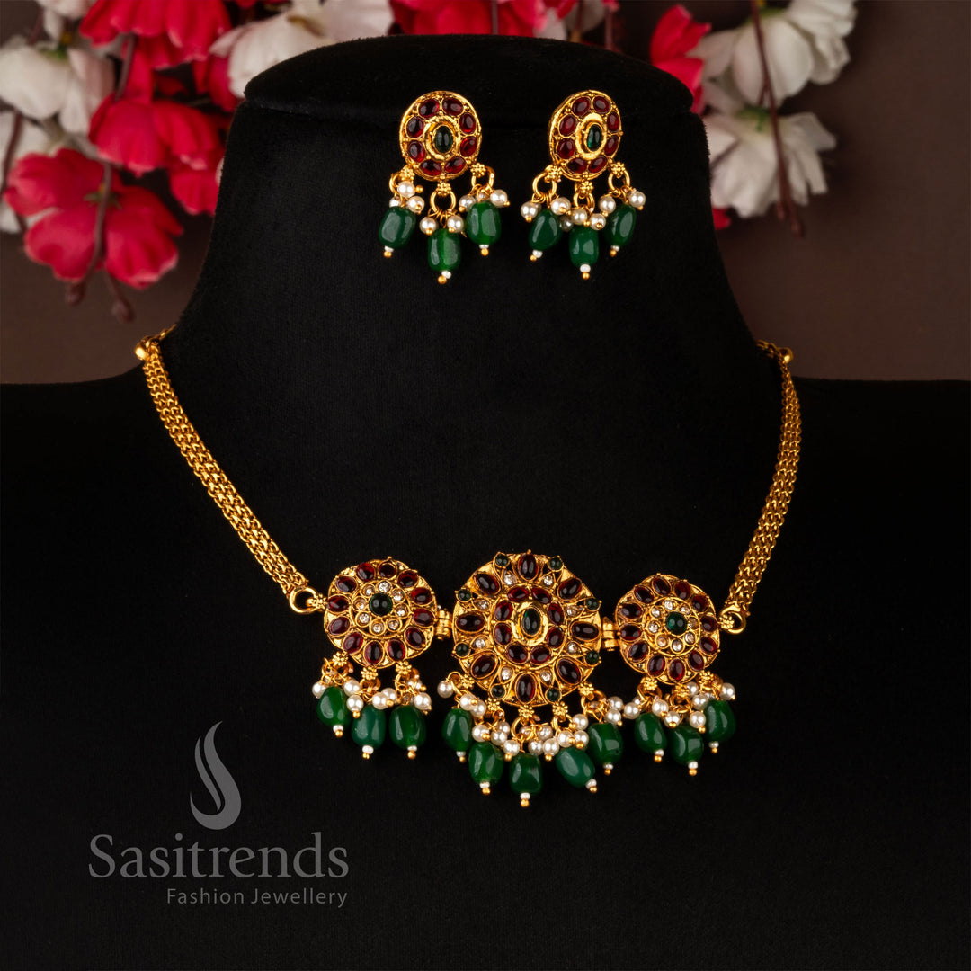 Classic matte gold temple choker set, featuring a delicate floral motif with ruby-green American diamonds, accompanied by elegant matching earrings - Sasitrends