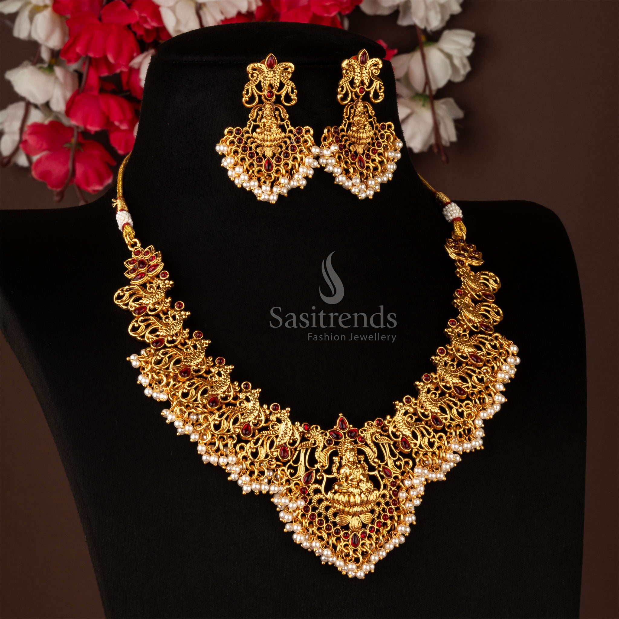 Artistic matte gold temple necklace jewellery set featuring divine Lakshmi motif with peacock embellishments and dazzling ruby stones - Sasitrends