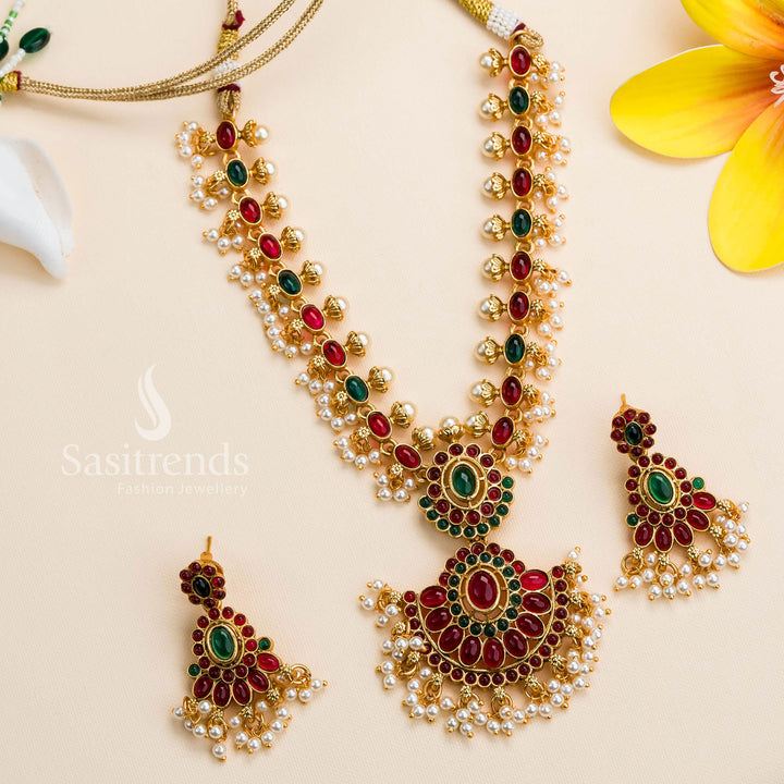 Intricately designed matte gold plated floral and oval ruby-green stone pendant necklace jewellery set, combining rich tradition with regal elegance - Sasitrends