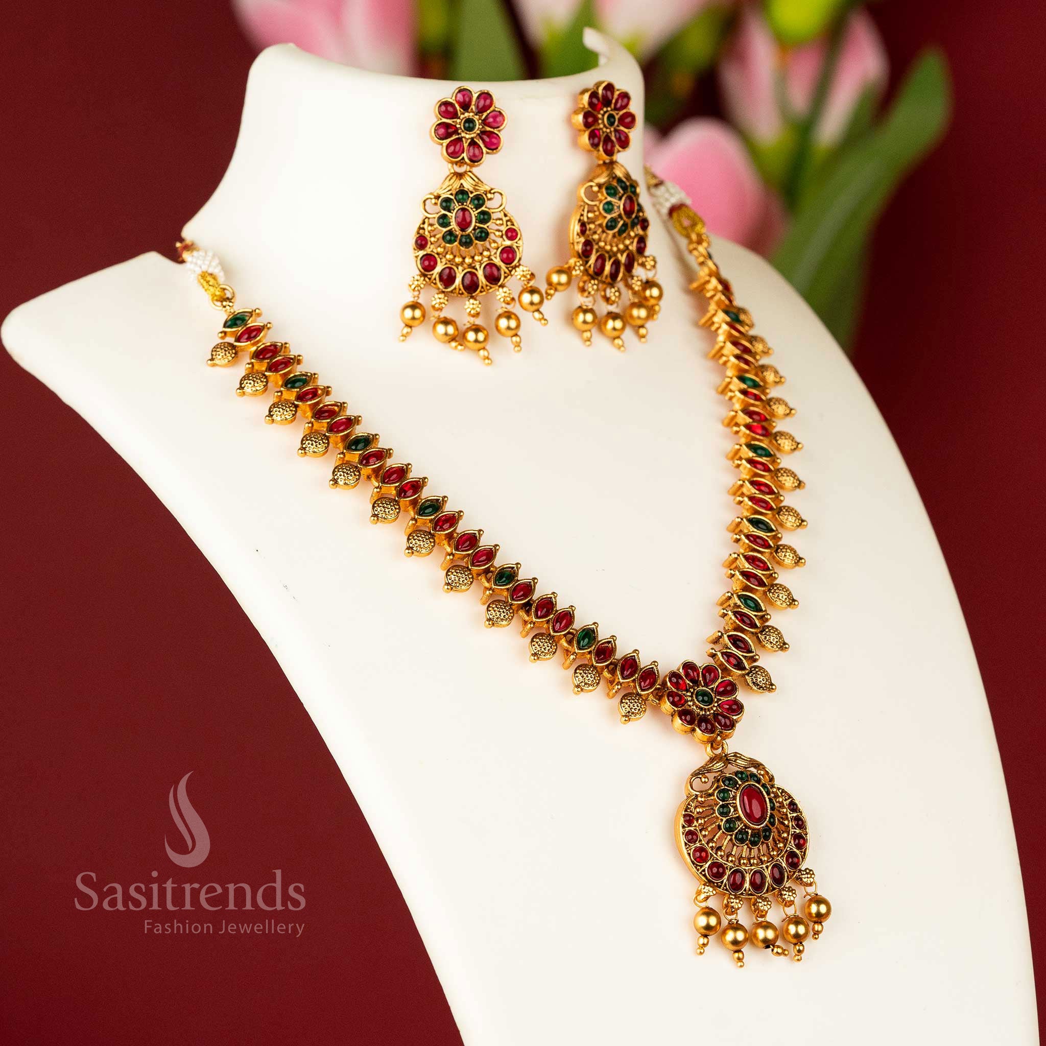 Majestic matte gold plated temple flower designer necklace jewellery set, intricately designed with ruby and green stones, a true masterpiece of traditional craftsmanship - Sasitrends
