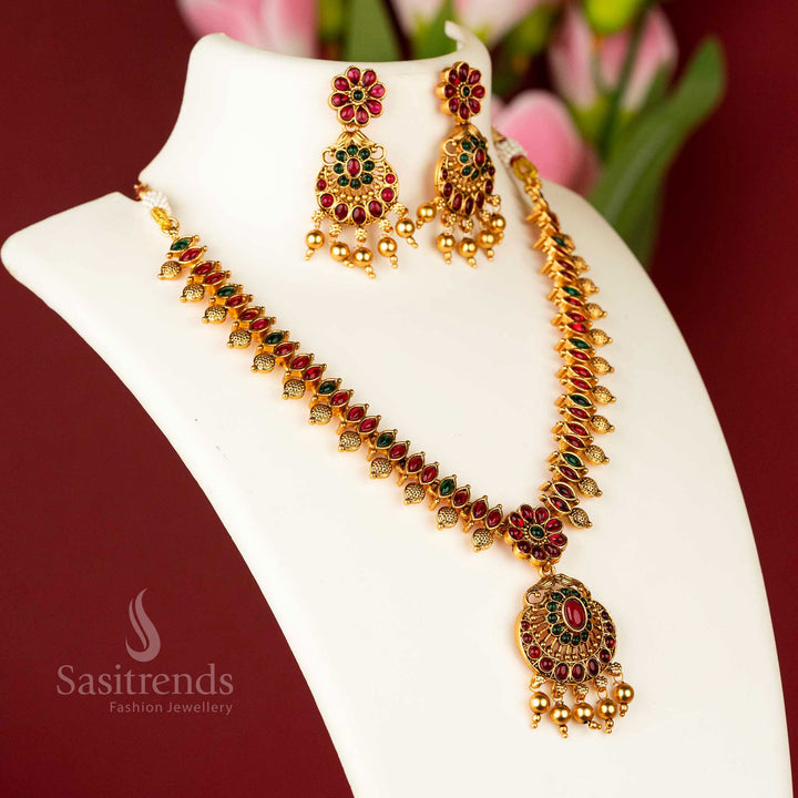 Majestic matte gold plated temple flower designer necklace jewellery set, intricately designed with ruby and green stones, a true masterpiece of traditional craftsmanship - Sasitrends