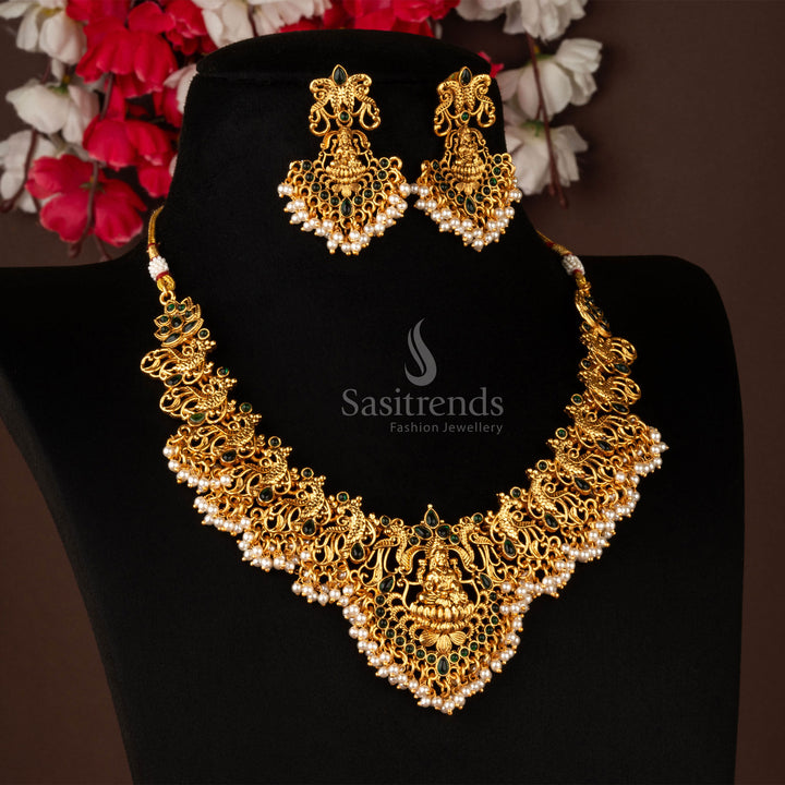 Classic matte gold plated Lakshmi peacock temple necklace jewellery set with vibrant green stones, showcasing intricate temple-style detailing in a royal vintage look - Sasitrends