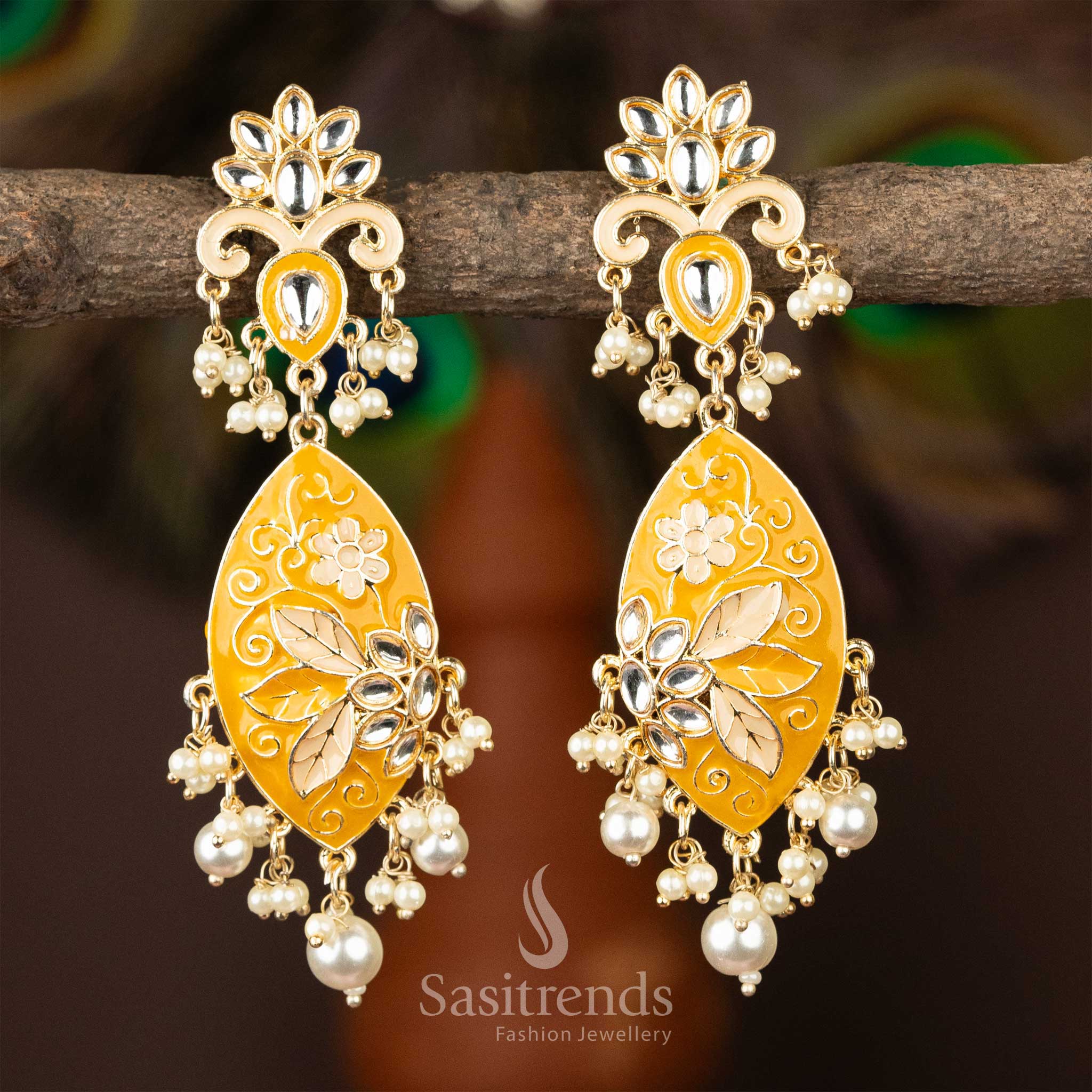 Ornate yellow enamel gold-plated kundan earrings with delicate pearls.