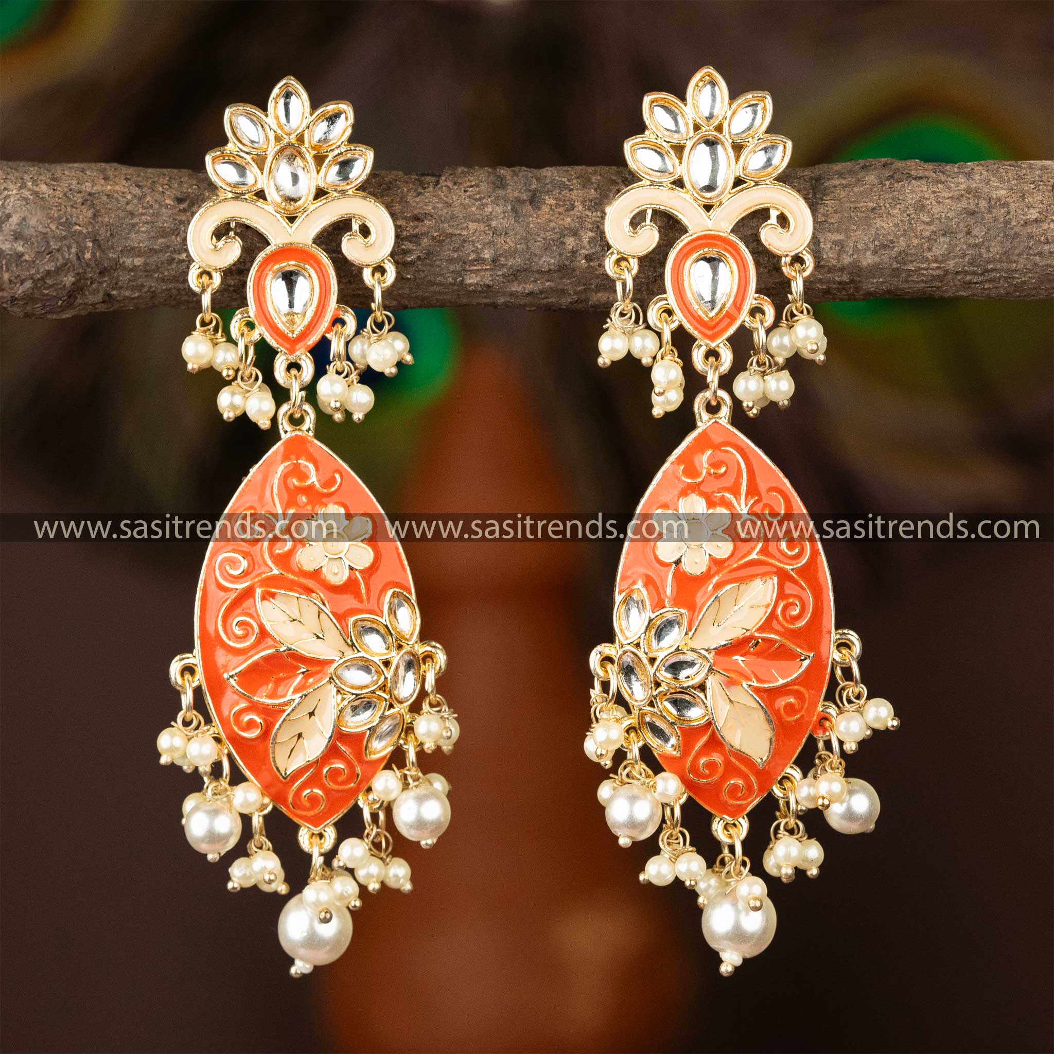 Regal red enamel and pearl embellished gold-plated kundan earrings.