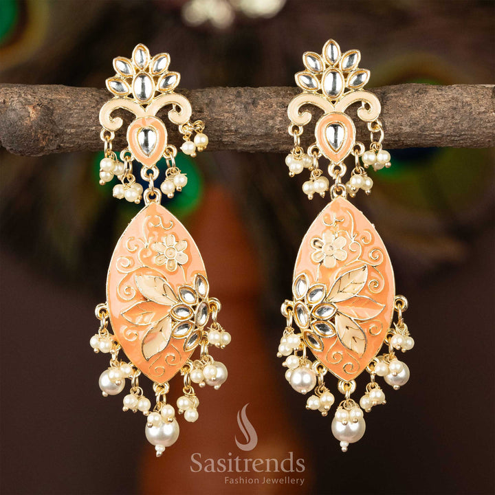 Charming peach enamel kundan earrings with gold plating and pearl dangles.