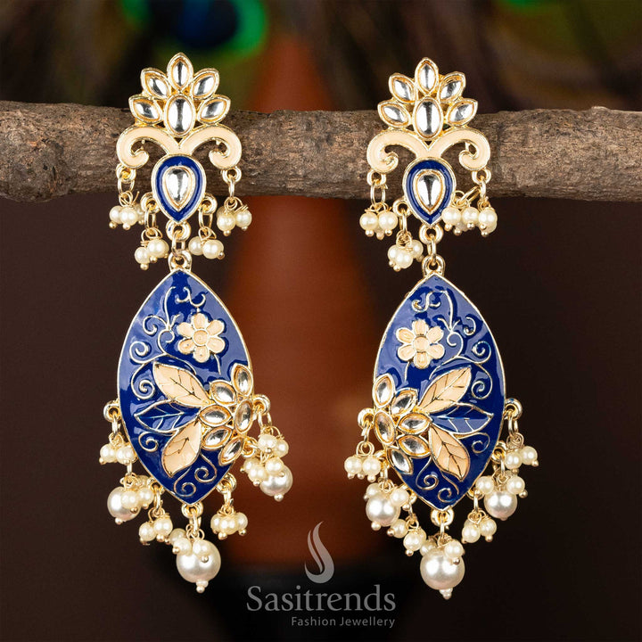 Sophisticated gold-plated kundan earrings with deep blue enamel and pearls.