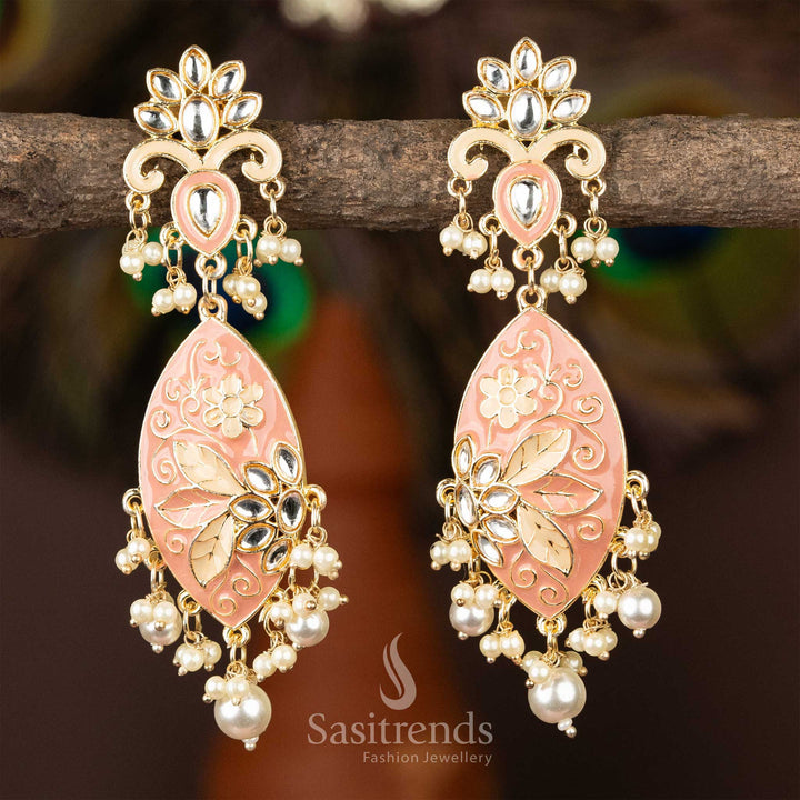 Elegant pink enamel kundan earrings with gold plating and pearl embellishments.