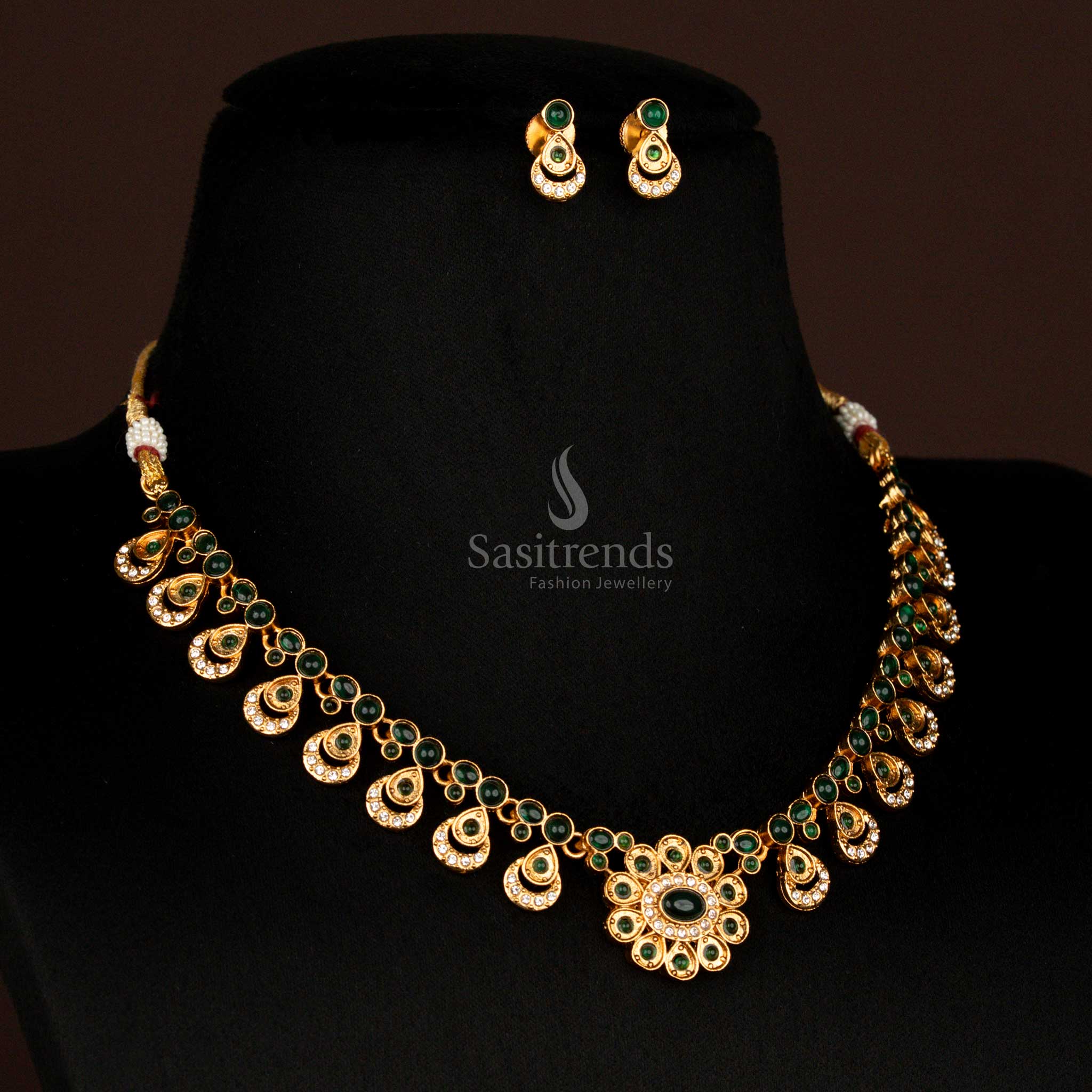 Graceful matte gold finish green floral design necklace set with oval pendant drops and matching earrings – classic temple-style jewellery for South Indian festivals – Sasitrends

