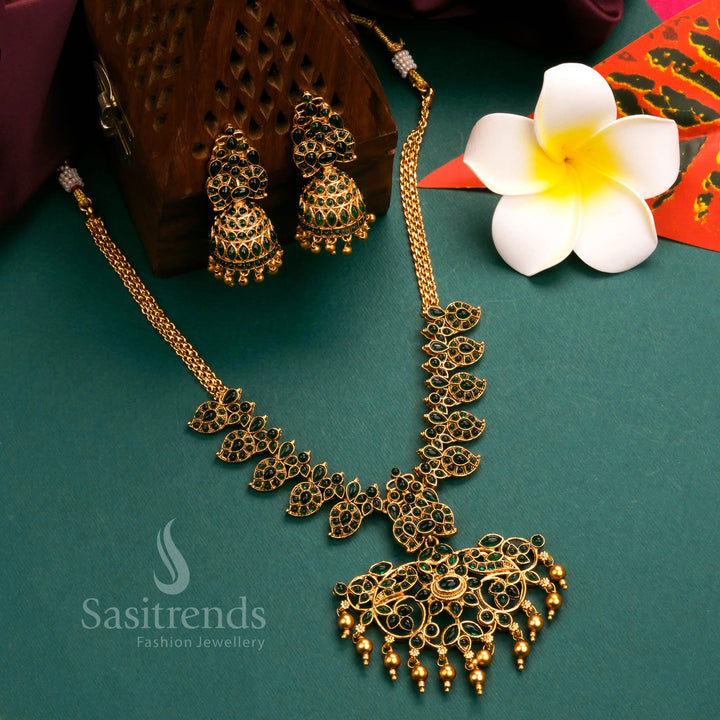 Artistic matte gold finish temple flower pendant necklace jewellery set, enriched with bold green stones for a majestic and ethnic aesthetic - Sasitrends