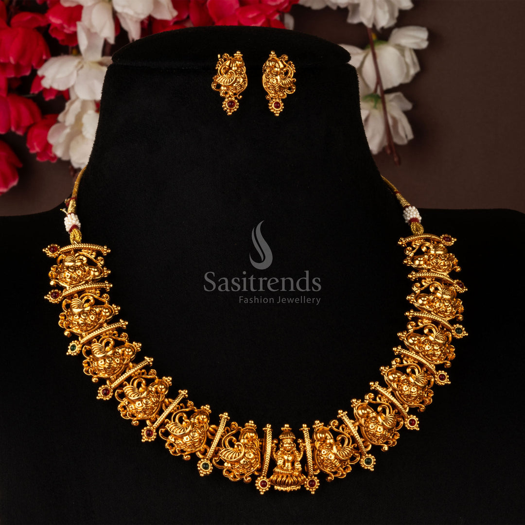 Temple inspired Lakshmi choker necklace with ruby-green Kemp stones and matching earrings, finished in matte gold – ethnic jewellery piece – sasitrends