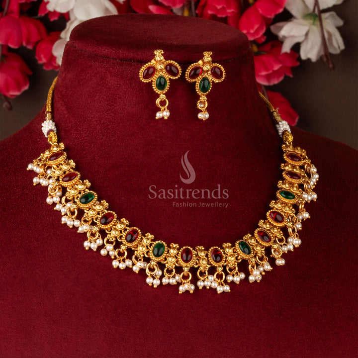 Dual-tone ruby-green Kemp necklace with classic matte gold plating and temple-inspired elegance – a festive jewellery pick – sasitrends