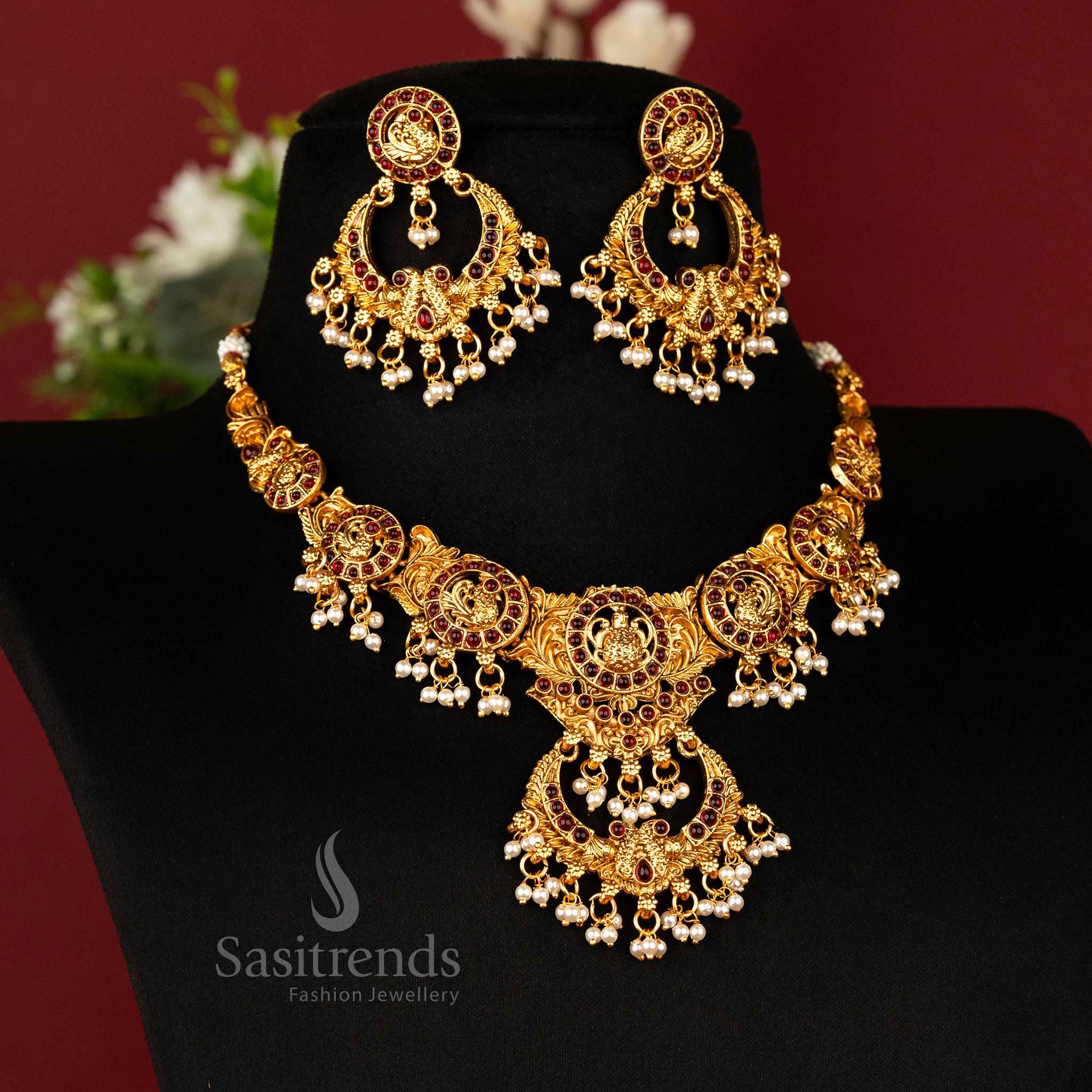 Regal matte gold-plated peacock temple necklace with chandbali pendant and rich ruby Kemp stones – graceful traditional wear jewellery – sasitrends
