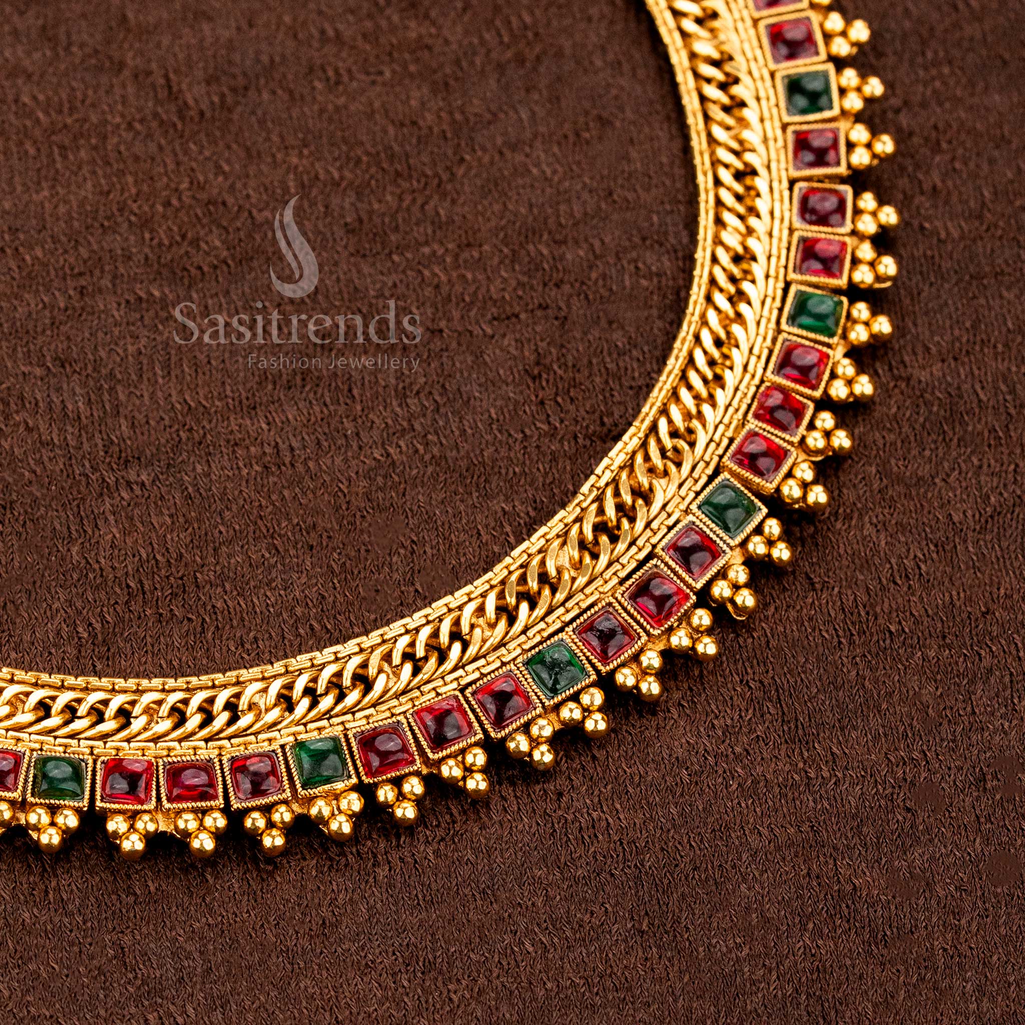 Grand traditional matte gold plated necklace set with striking square motif ruby-green stones, specially designed for the temple bride’s jewellery style and rich heritage aura by Sasitrends