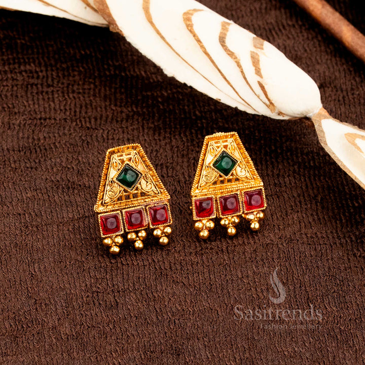 Elegant matte gold plated Ruby-green square stone temple necklace set crafted for brides, blending traditional festive jewellery glamour and rich temple artistry by Sasitrends