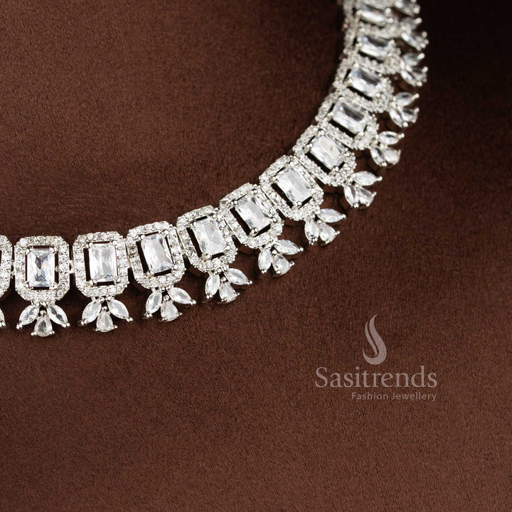 White American Diamond drop earrings with a floral stud and a rectangular stone centerpiece in a rhodium silver finish - Sasitrends