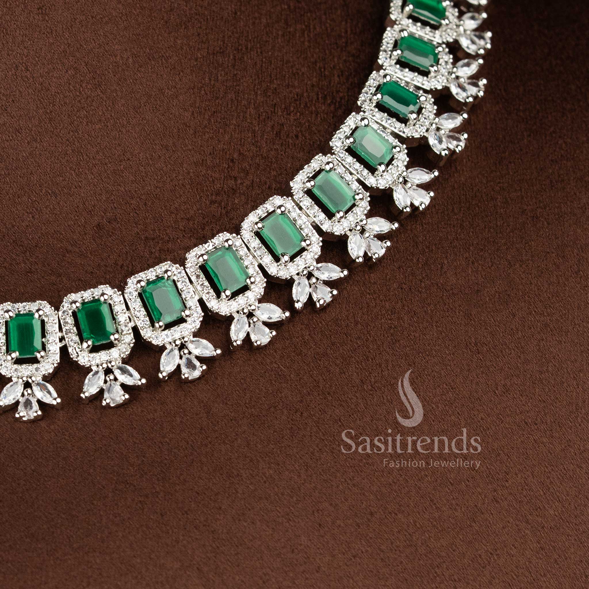 Elegant green American Diamond drop earrings with a floral stud and a rectangular emerald-green stone centerpiece in a rhodium silver finish 2021C - Sasitrends